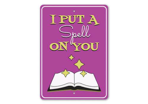 Purple "I Put a Spell on You" metal sign with an open magical book design for Halloween decor
