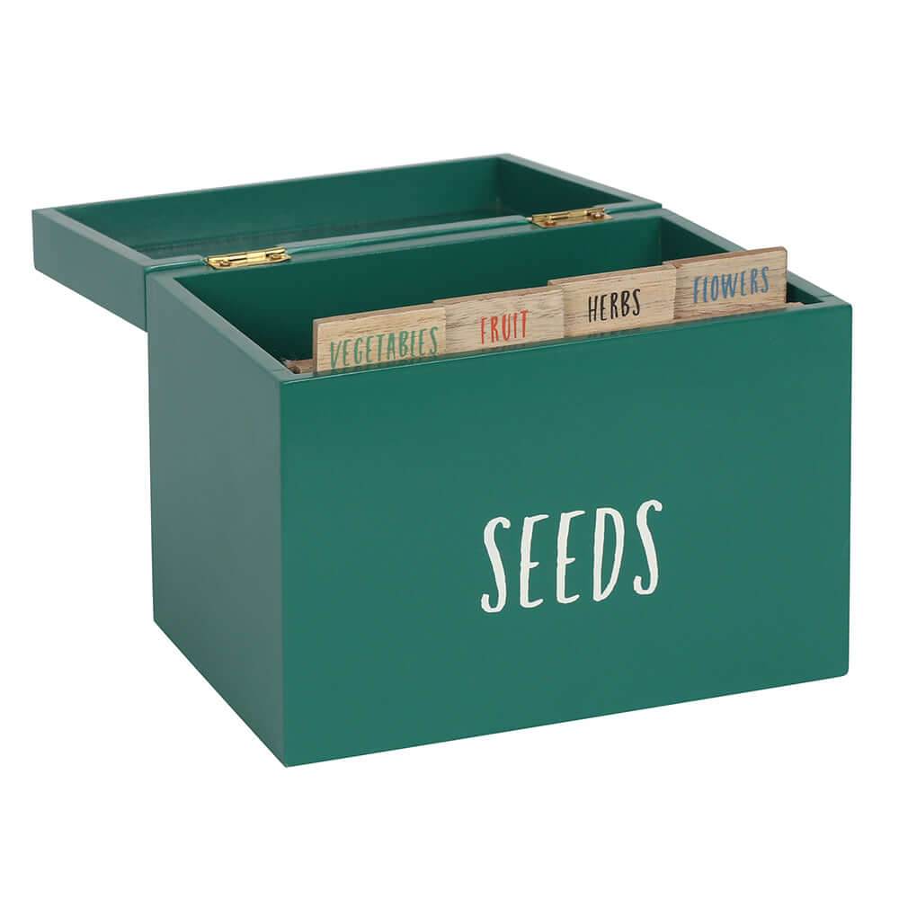 Green seed storage box with dividers labeled vegetables, fruit, herbs, and flowers for organizing seeds.