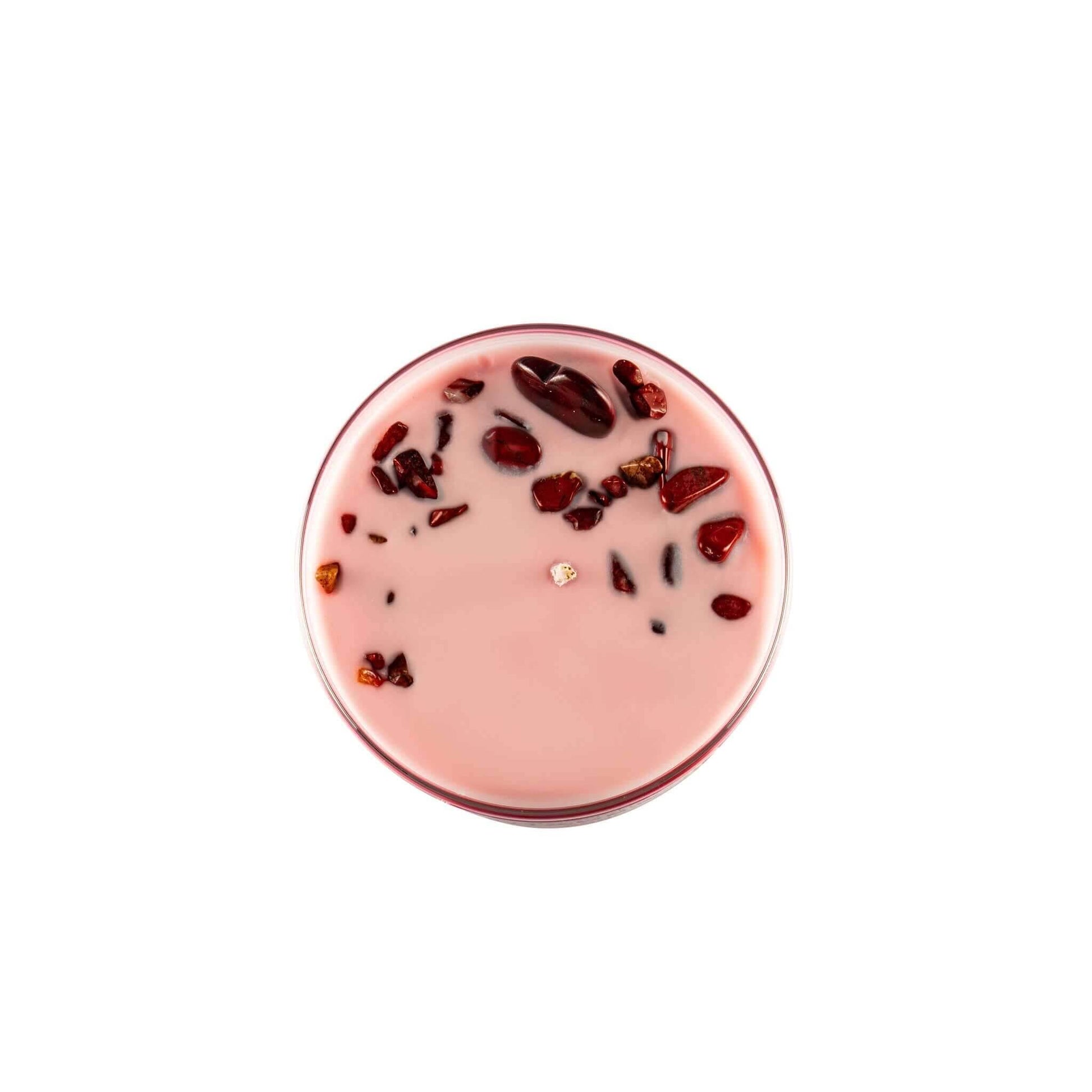 Top view of Chakra 1 Red Jasper gemstone soy candle with red jasper crystals embedded in pink wax.