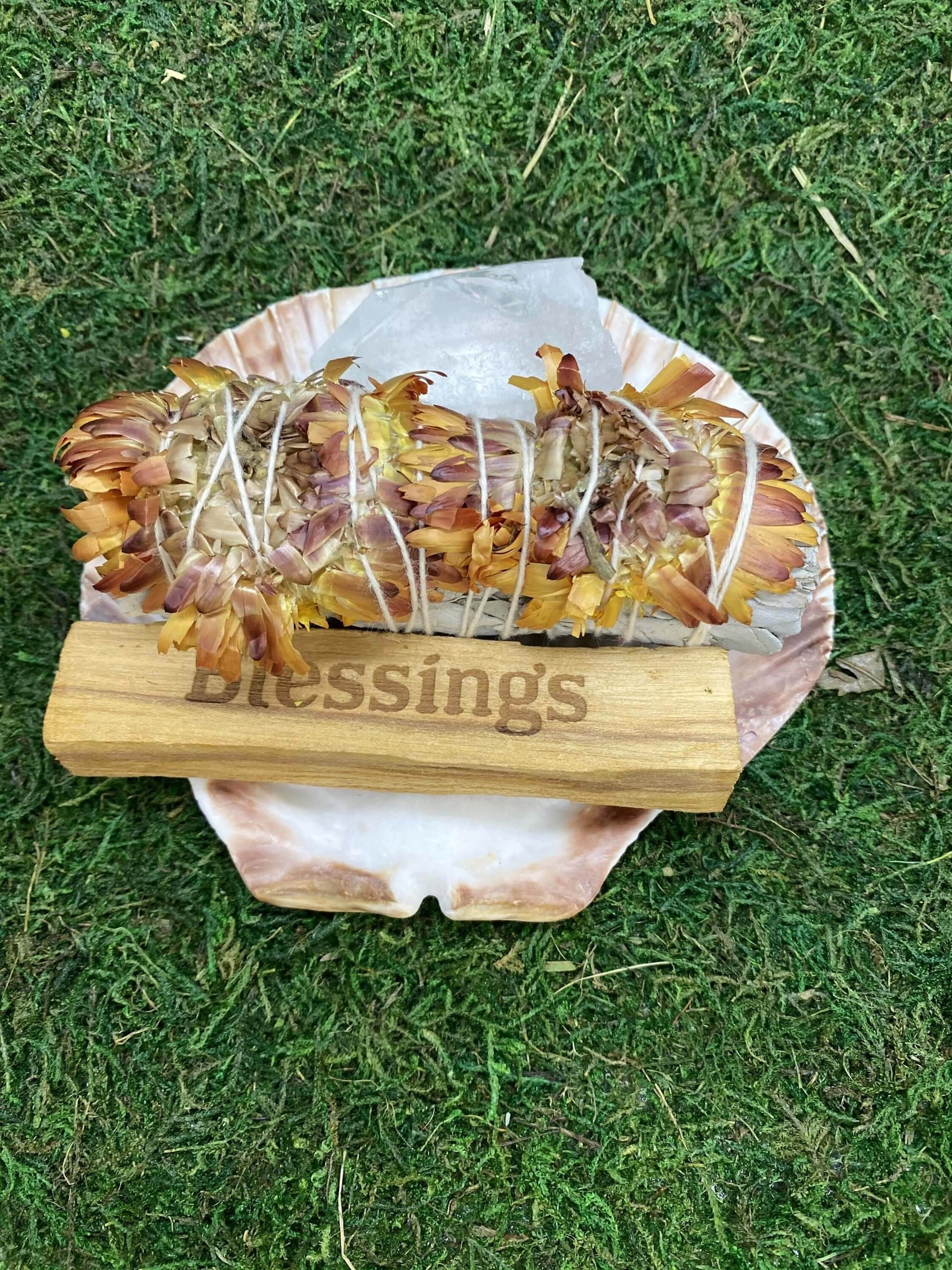 Blessing Smudge Kit with Floral Sage, Palo Santo stick, Clear Quartz, and shell dish on green grass